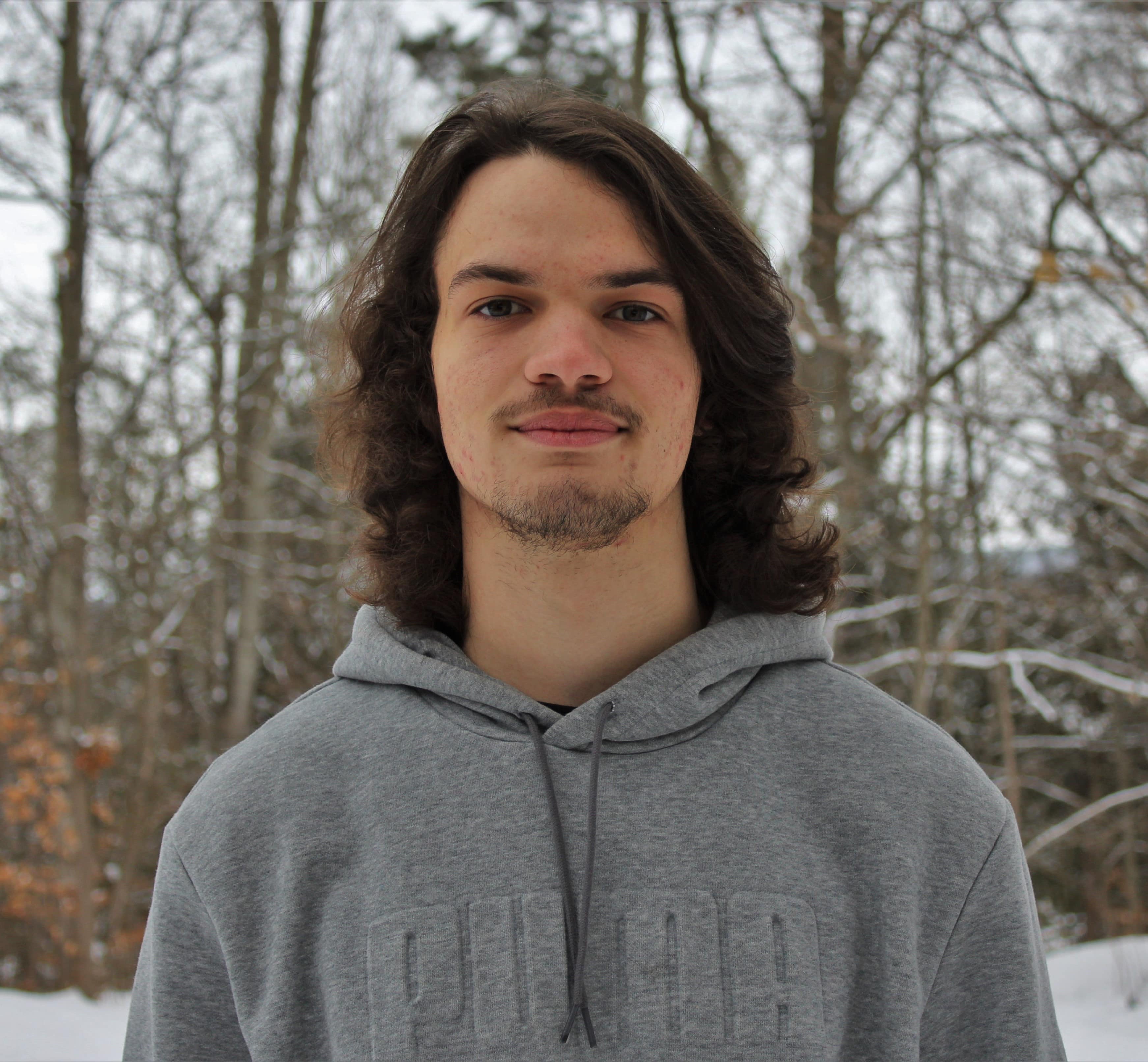 picture of Jesse with bare trees in the background